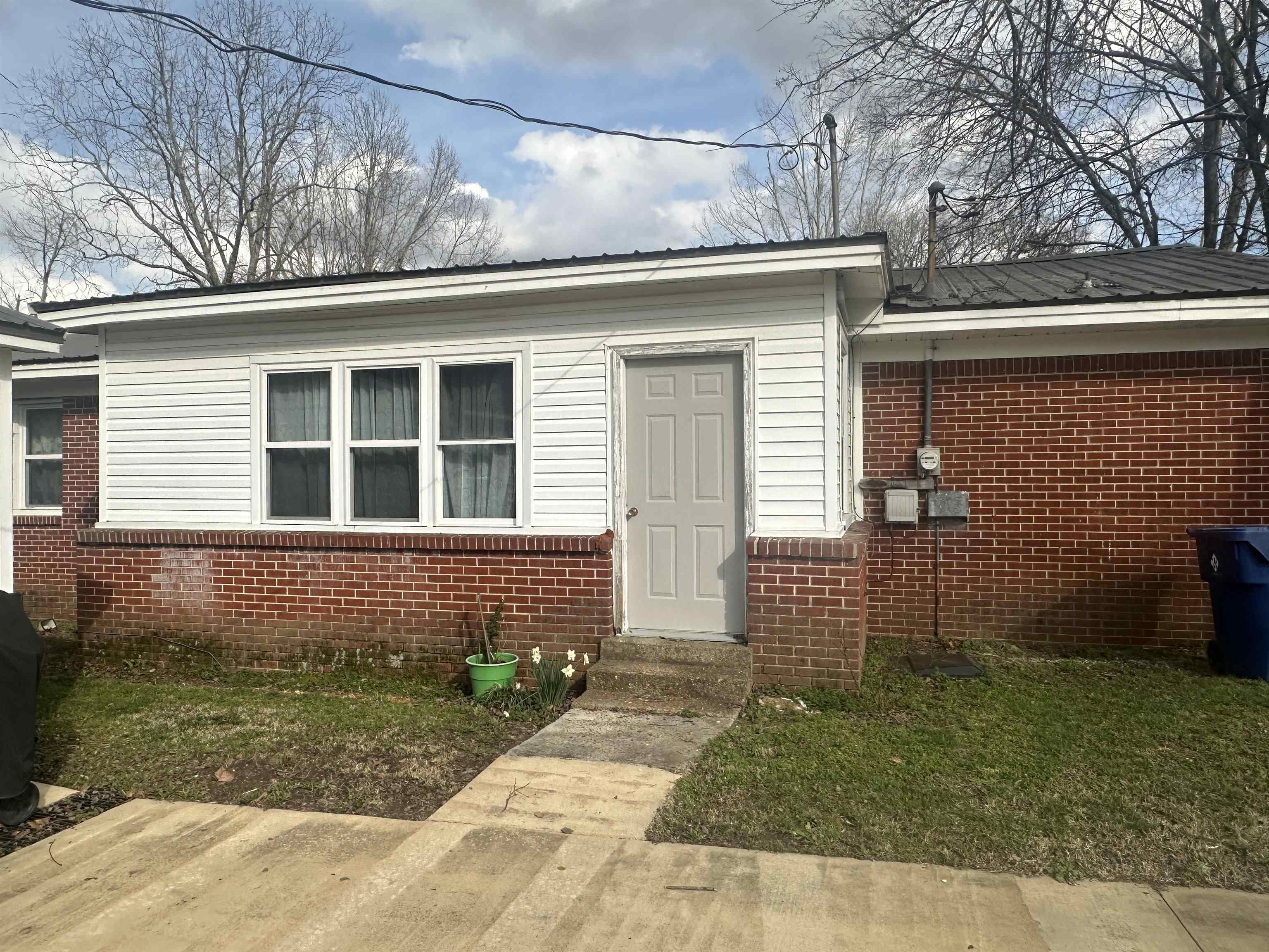 123 North Magnolia Street Adamsville, TN 38310 - Photo 9 of 25 a front view of a house with garden