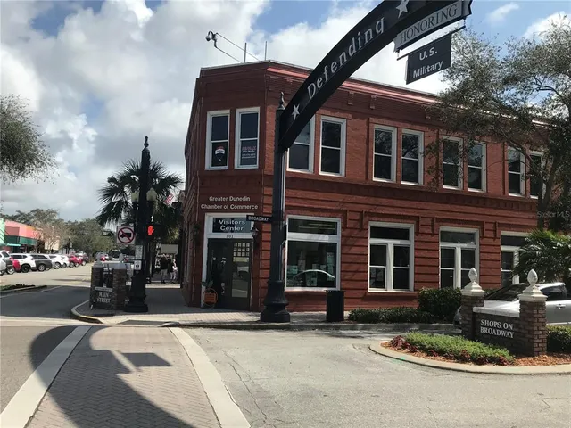 a view of a brick building next to a road
