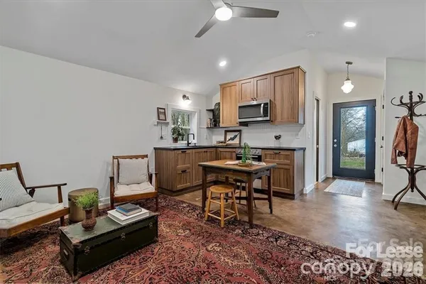 a living room with furniture a rug and a flat screen tv