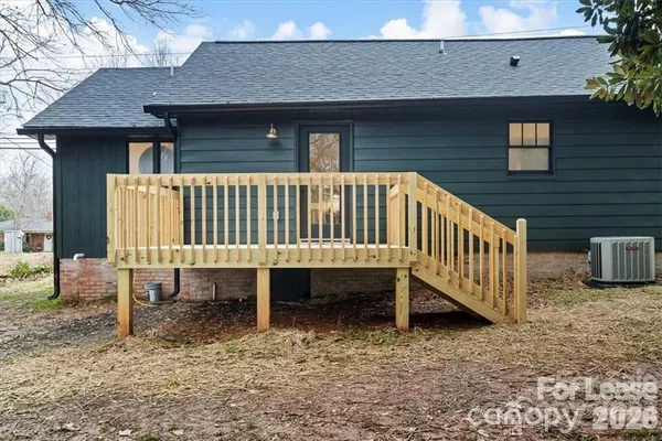 a view of a house with a yard and deck
