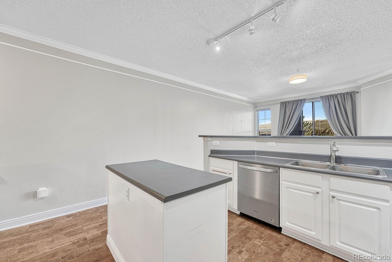 2149 Eagle Avenue Superior, CO 80027 - Photo 11 of 31 a kitchen with a sink and a refrigerator