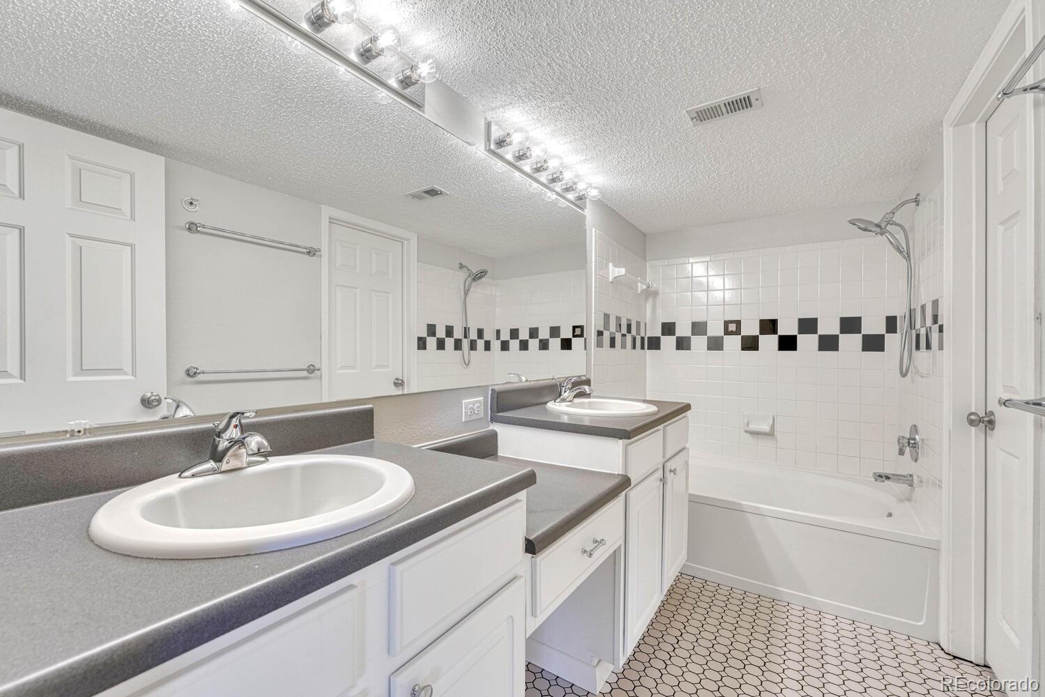 2149 Eagle Avenue Superior, CO 80027 - Photo 24 of 31 a bathroom with a sink double vanity granite tub and a mirror
