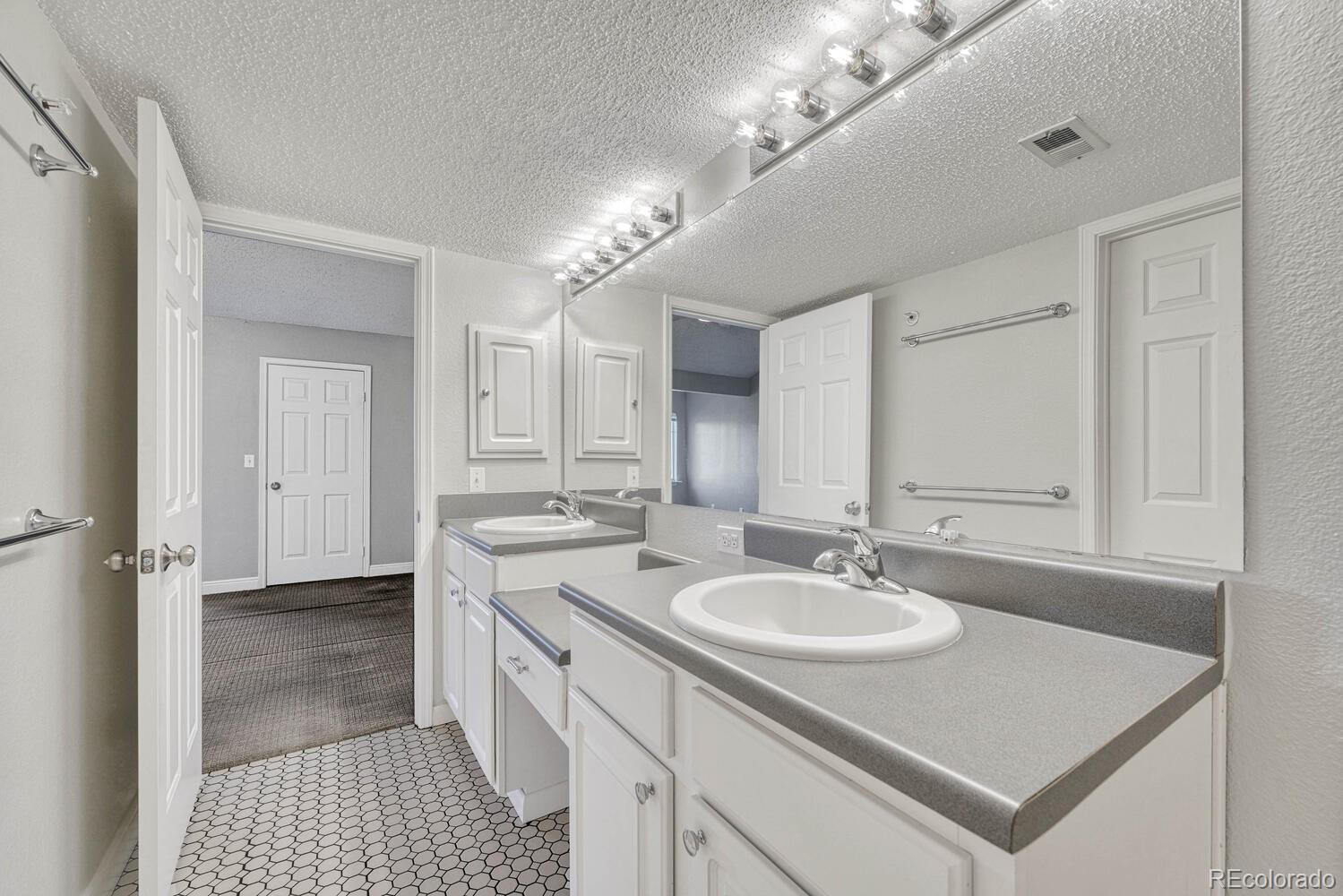 2149 Eagle Avenue Superior, CO 80027 - Photo 25 of 31 a bathroom with a sink double vanity and a mirror