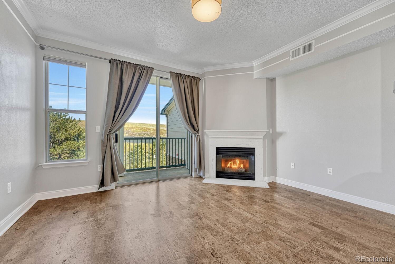 2149 Eagle Avenue Superior, CO 80027 - Photo 5 of 31 wooden floor fireplace and windows in an empty room