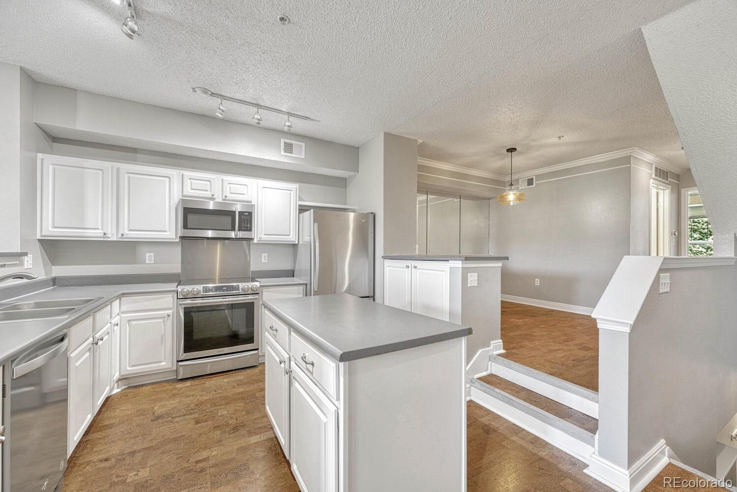 2149 Eagle Avenue Superior, CO 80027 - Photo 9 of 31 a kitchen with stainless steel appliances granite countertop a sink and a refrigerator