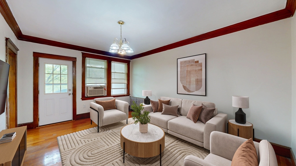 26 Chiswick Road, Unit 13 Boston, MA 02135 - Photo 1 of 11 a living room with furniture and a chandelier