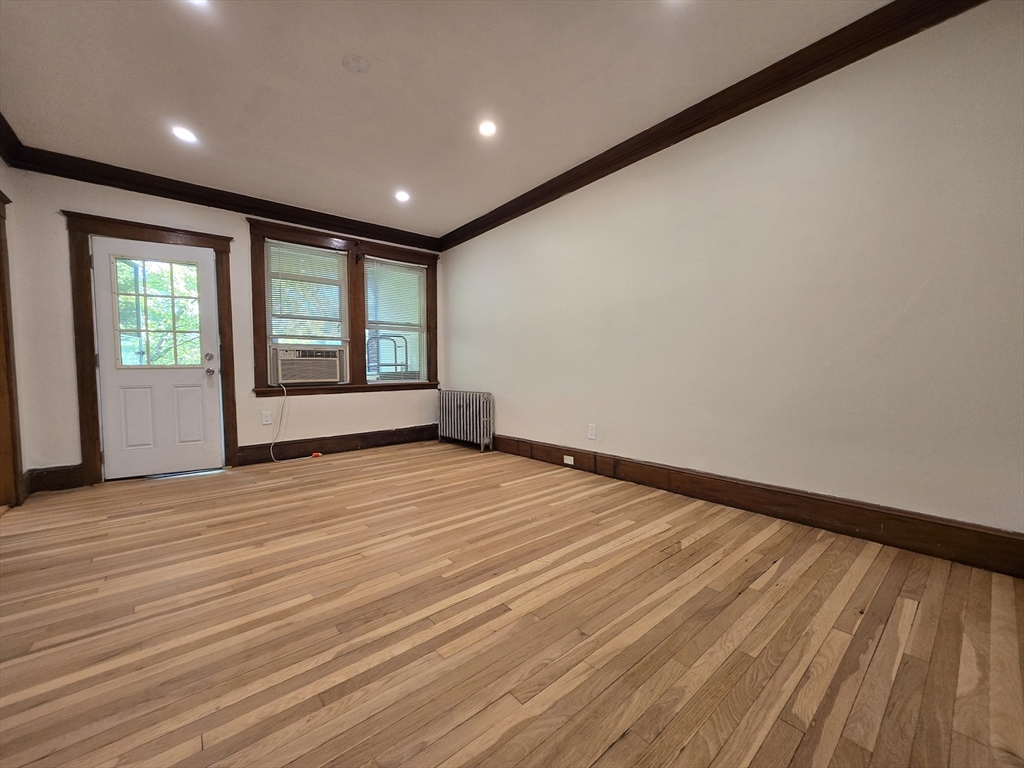 26 Chiswick Road, Unit 13 Boston, MA 02135 - Photo 2 of 11 an empty room with wooden floor and windows