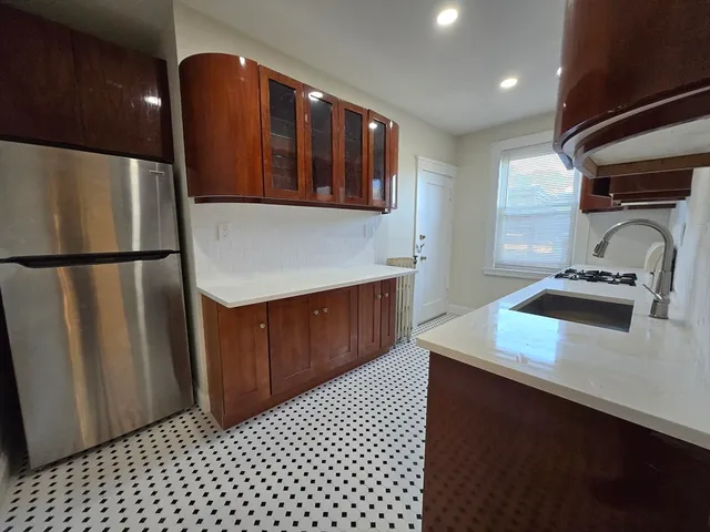 a kitchen with a refrigerator and a sink