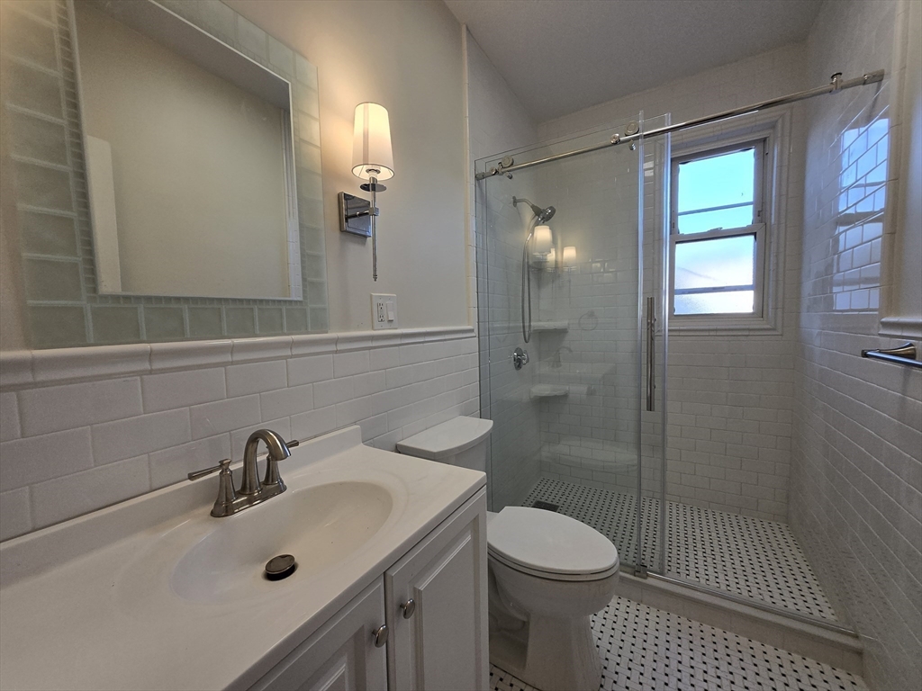 26 Chiswick Road, Unit 13 Boston, MA 02135 - Photo 5 of 11 a bathroom with a sink toilet and shower