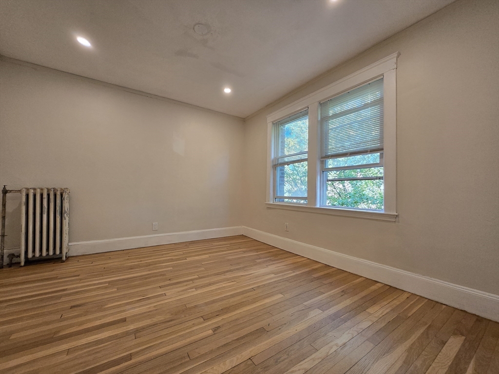 26 Chiswick Road, Unit 13 Boston, MA 02135 - Photo 8 of 11 an empty room with wooden floor and windows