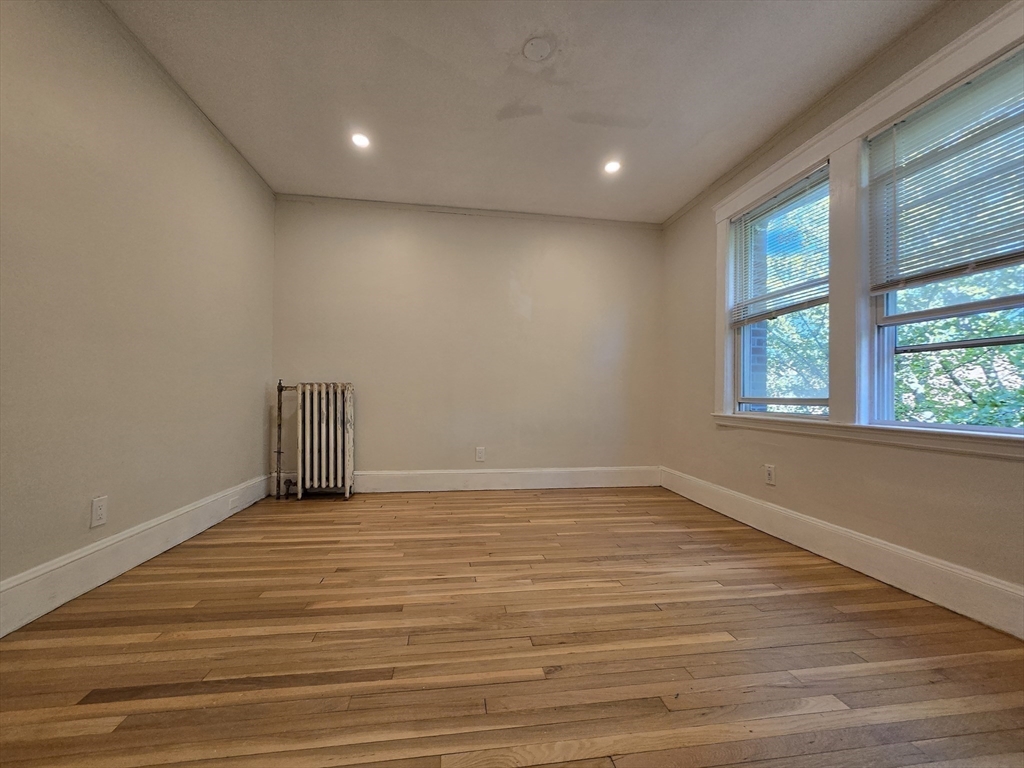 26 Chiswick Road, Unit 13 Boston, MA 02135 - Photo 9 of 11 a view of an empty room with wooden floor and a window
