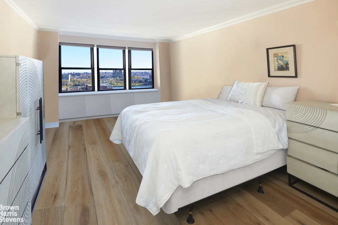 460 East 79th Street, Unit 16A Manhattan, NY 10075 - Photo 10 of 20 a large bed sitting in a bedroom next to a window