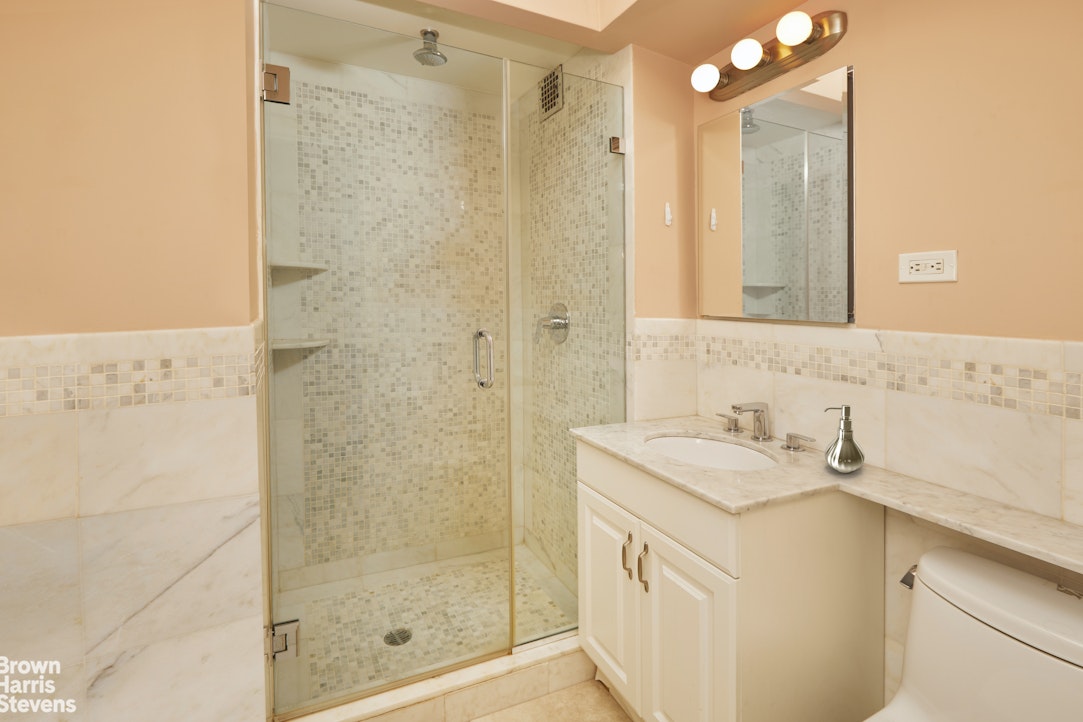 460 East 79th Street, Unit 16A Manhattan, NY 10075 - Photo 12 of 20 a bathroom with a sink and a mirror