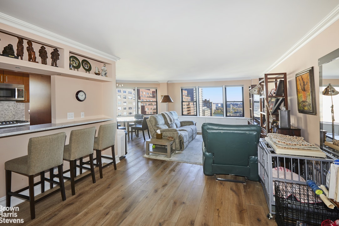 460 East 79th Street, Unit 16A Manhattan, NY 10075 - Photo 15 of 20 a living room with furniture and a wooden floor