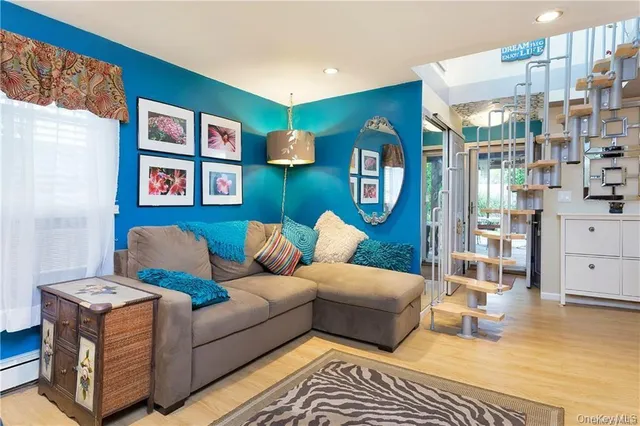 a living room with furniture and painting on the wall