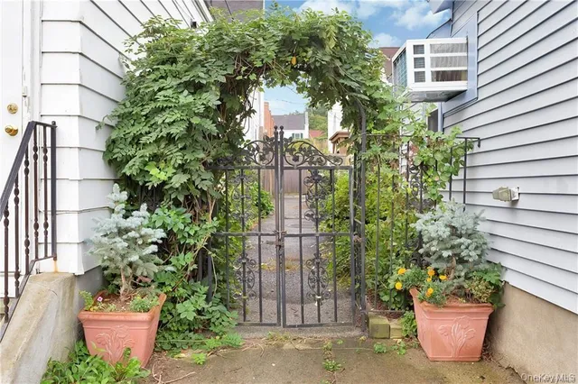 a front view of a house with a garden