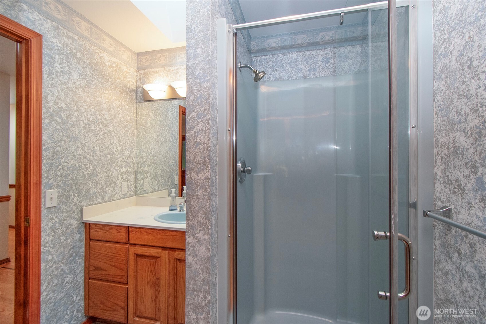 99 South Point Road Port Angeles, WA 98363 - Photo 26 of 40 a bathroom with a granite countertop shower a mirror and a sink