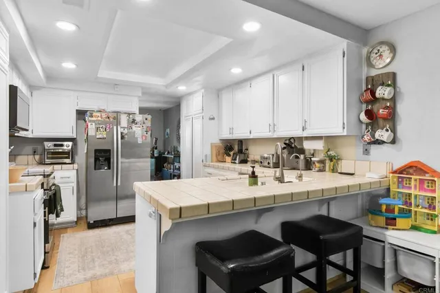 a kitchen with a sink cabinets and refrigerator