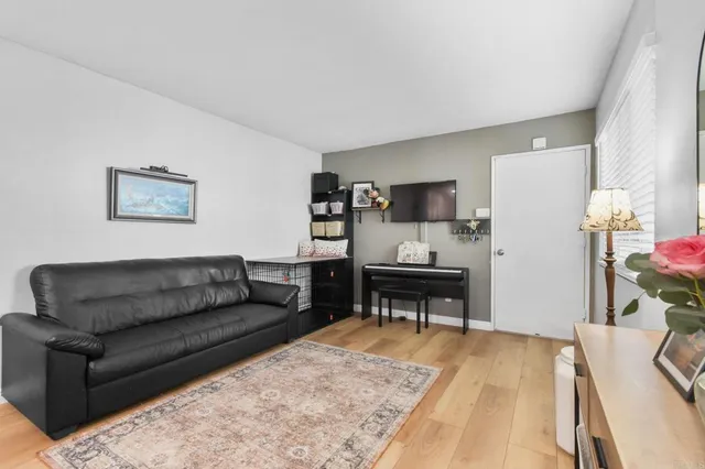a living room with furniture and a dining table