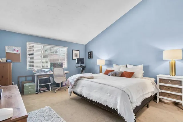 a bedroom with a bed a desk and chair