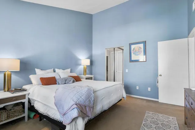 a bedroom with a bed and a lamp