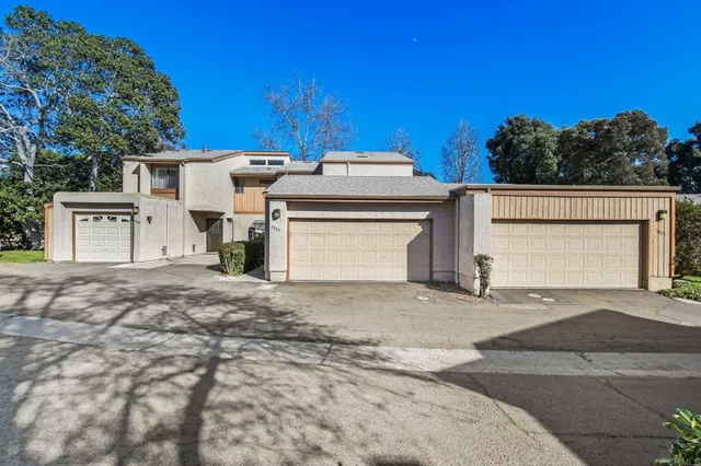 a view of a house with a yard and garage