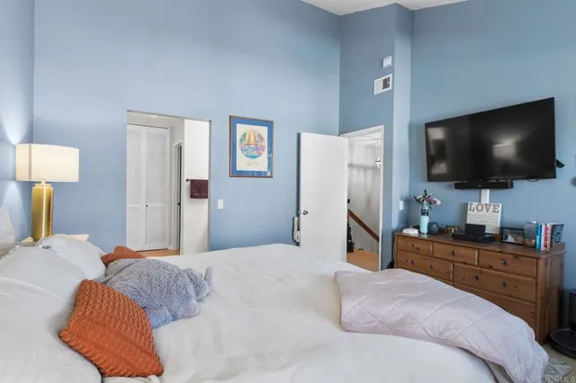 a bedroom with a bed and a flat screen tv