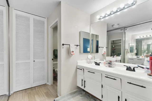 a bathroom with a double vanity sink and a mirror