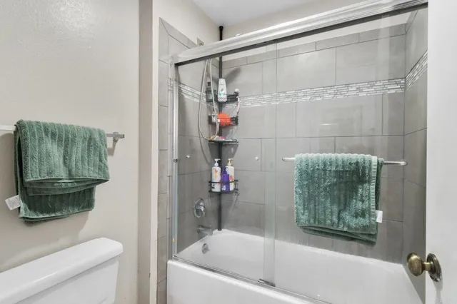 a bathroom with a shower and a toilet