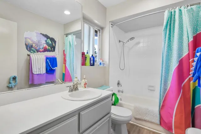 a bathroom with a sink vanity mirror and toilet