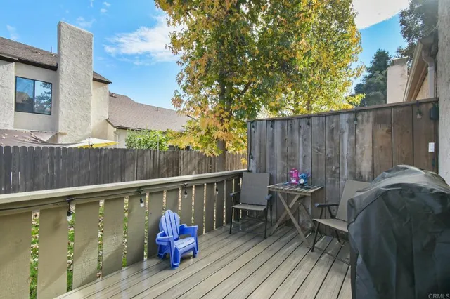 a view of deck with table and chairs and wooden floor