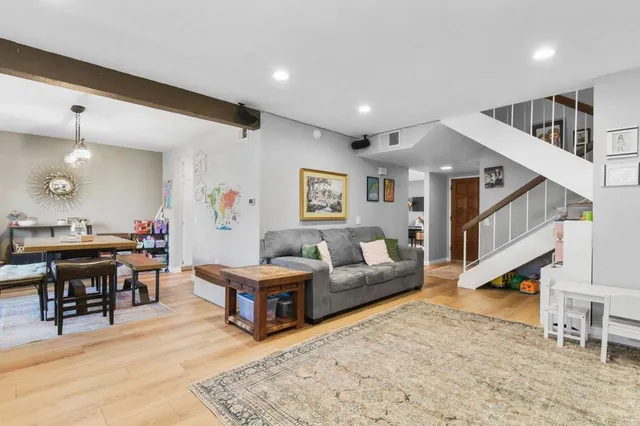 a living room with furniture and wooden floor