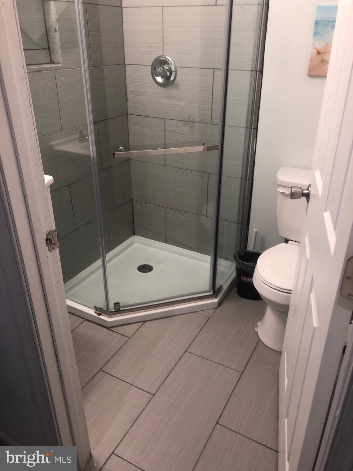 1002 8th Street Laurel, MD 20707 - Photo 11 of 19 a bathroom with a shower and a toilet