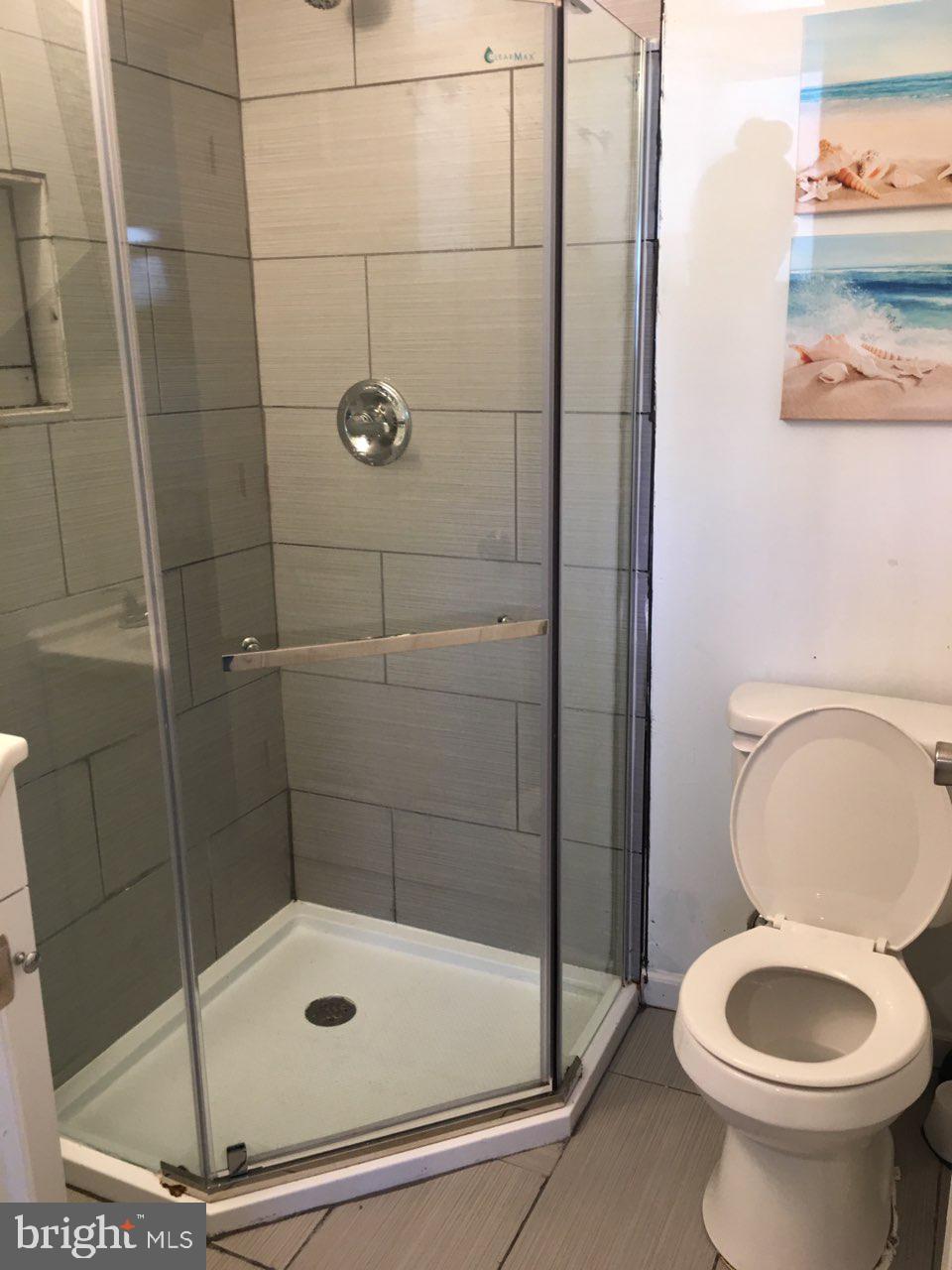 1002 8th Street Laurel, MD 20707 - Photo 16 of 19 a bathroom with a toilet and a shower