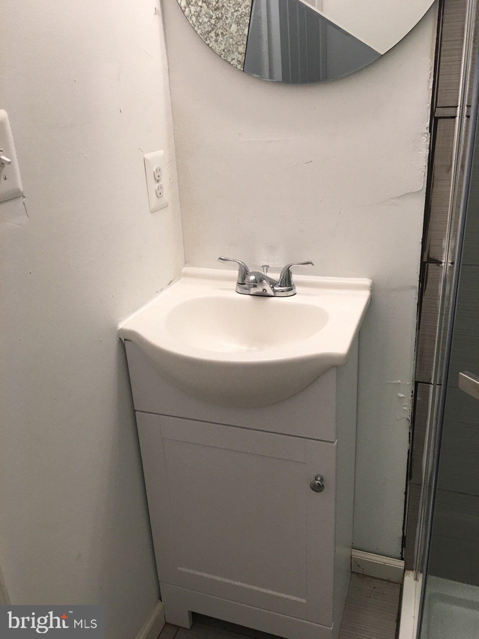 1002 8th Street Laurel, MD 20707 - Photo 17 of 19 a sink and a mirror