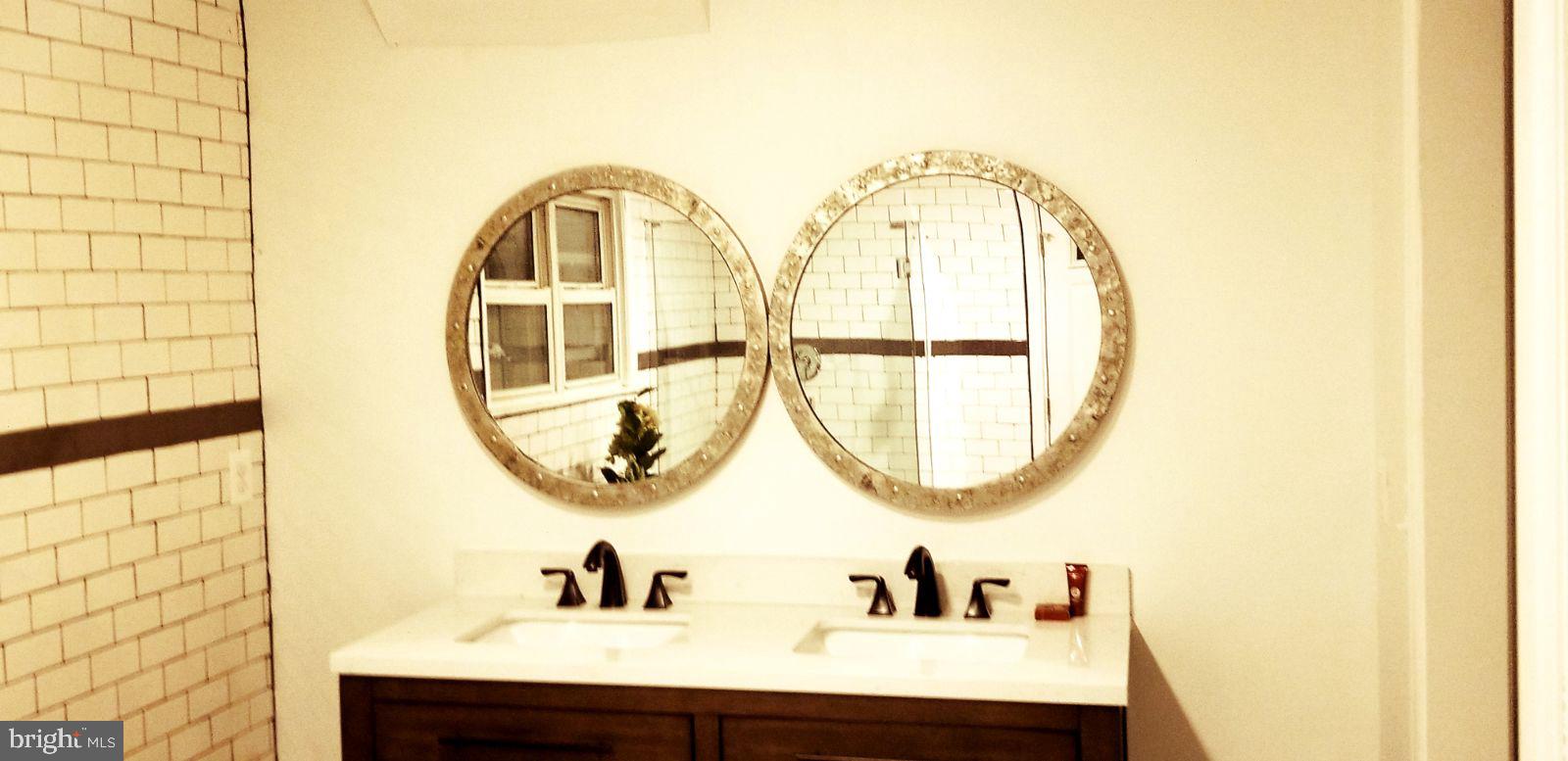 1002 8th Street Laurel, MD 20707 - Photo 18 of 19 a bathroom with a sink and a mirror