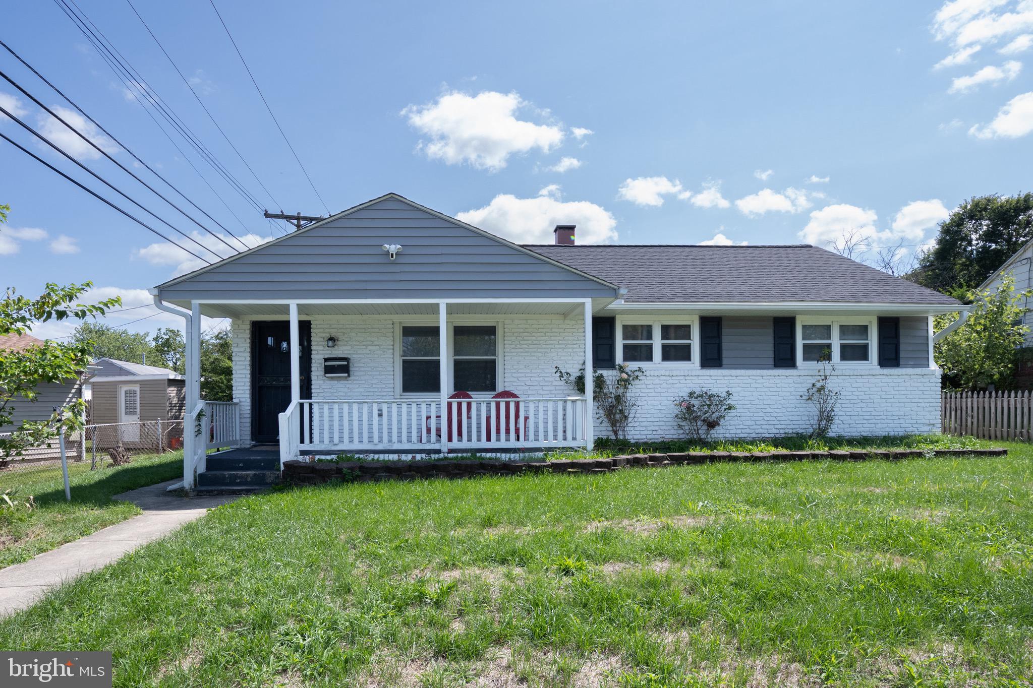 1002 8th Street Laurel, MD 20707 - Photo 2 of 19 a front view of a house with a garden and yard