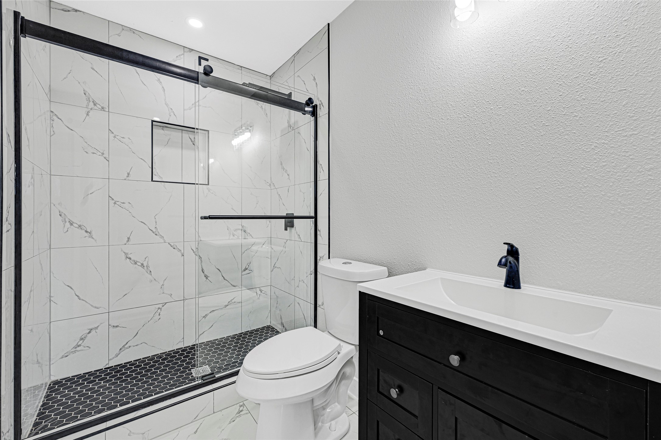 5213 Shirley Street Baytown, TX 77521 - Photo 4 of 12 a bathroom with a sink toilet and shower