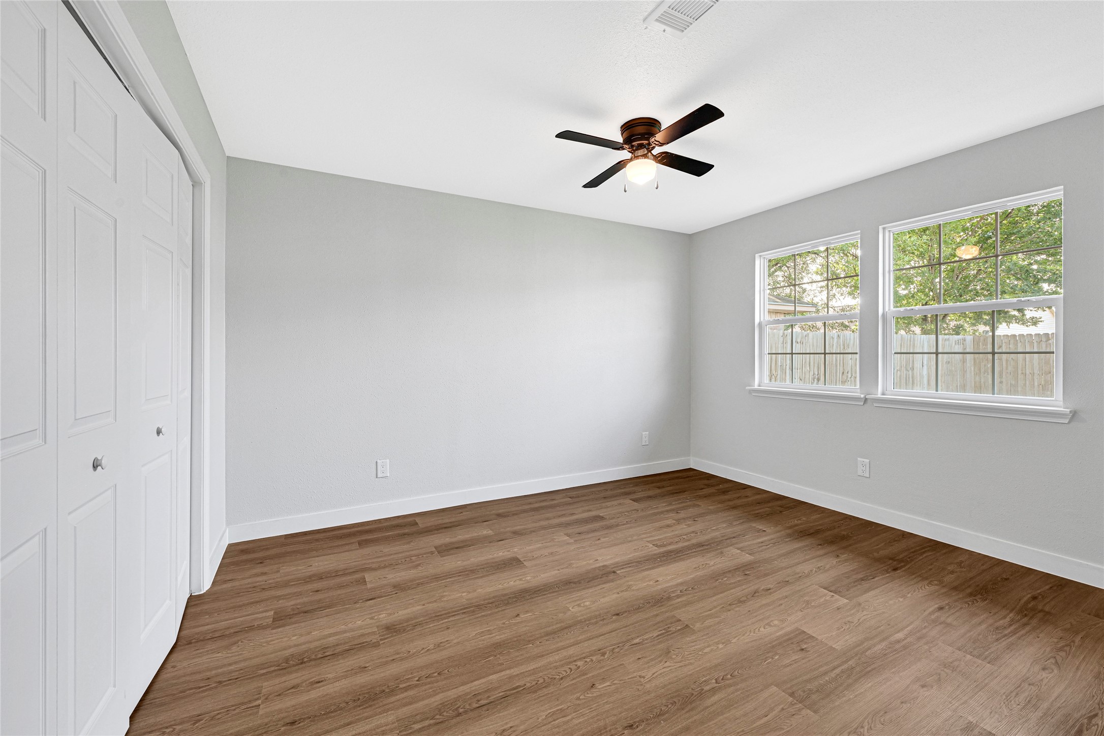 5213 Shirley Street Baytown, TX 77521 - Photo 7 of 12 a view of an empty room with wooden floor and a window