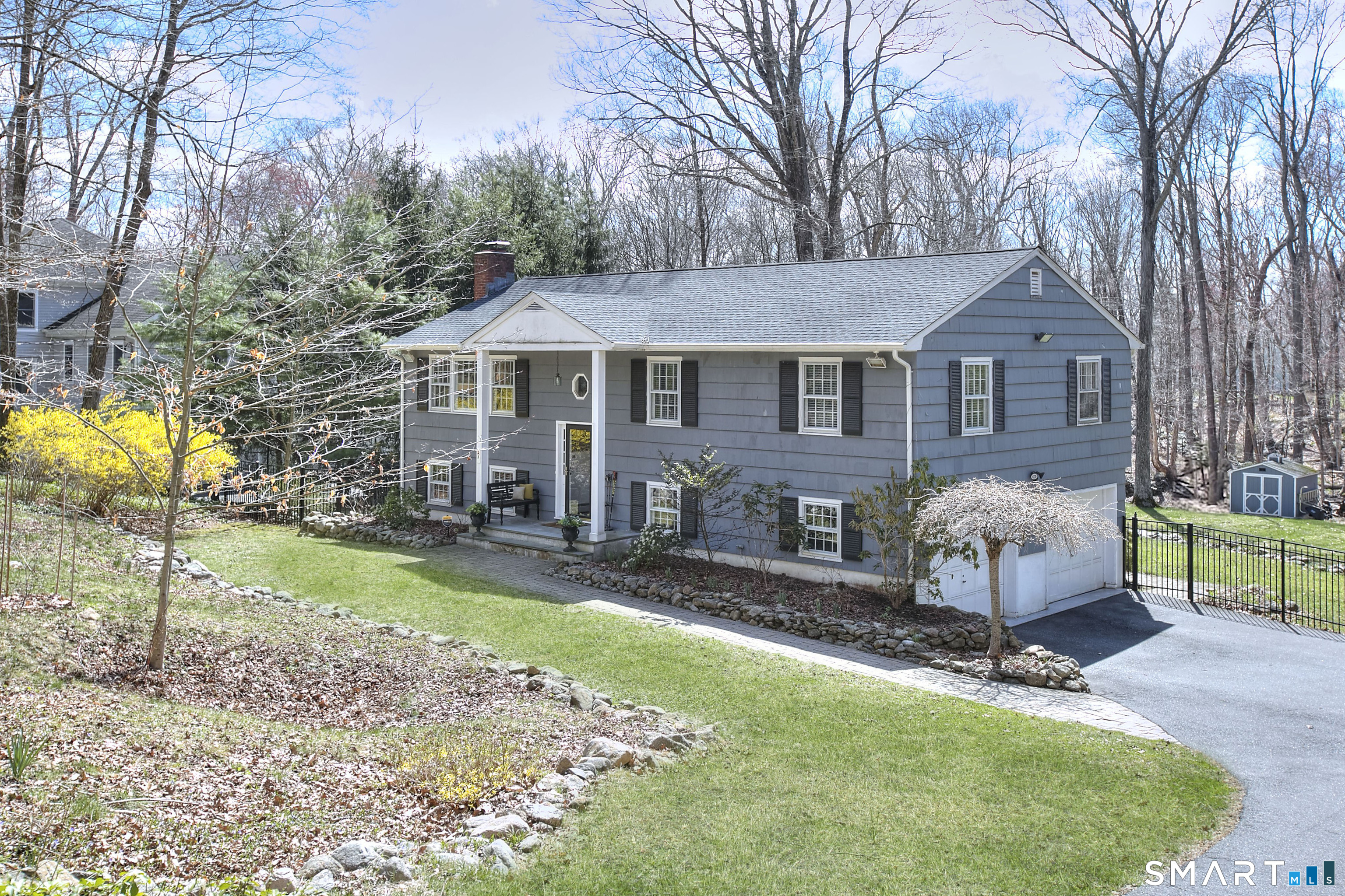 a view of a house with a yard and sitting area