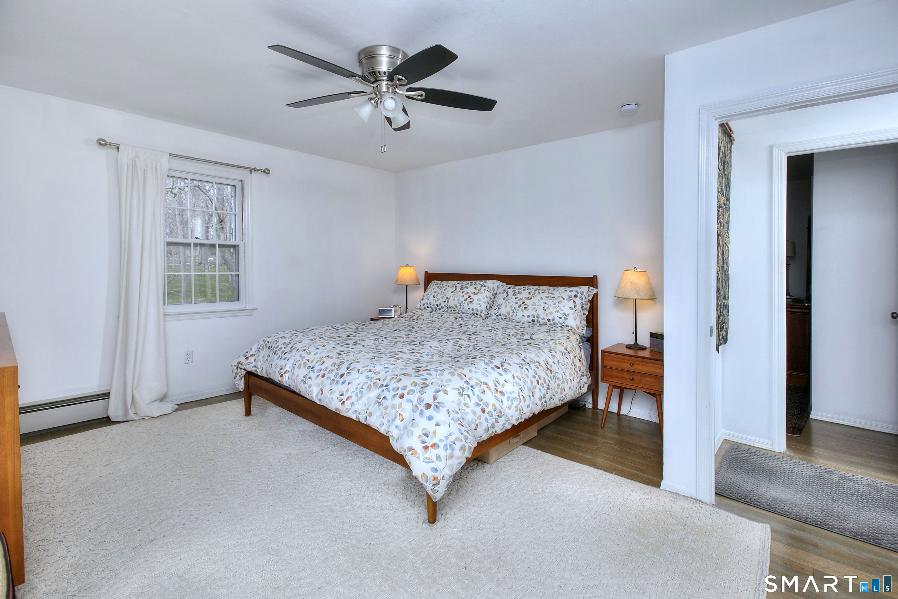 7 Richmond Hill Road Weston, CT 06883 - Photo 20 of 33 a bedroom with a bed and a chandelier
