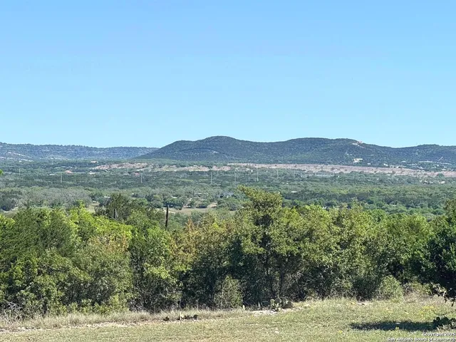 a view of a large mountain with a mountain in the background