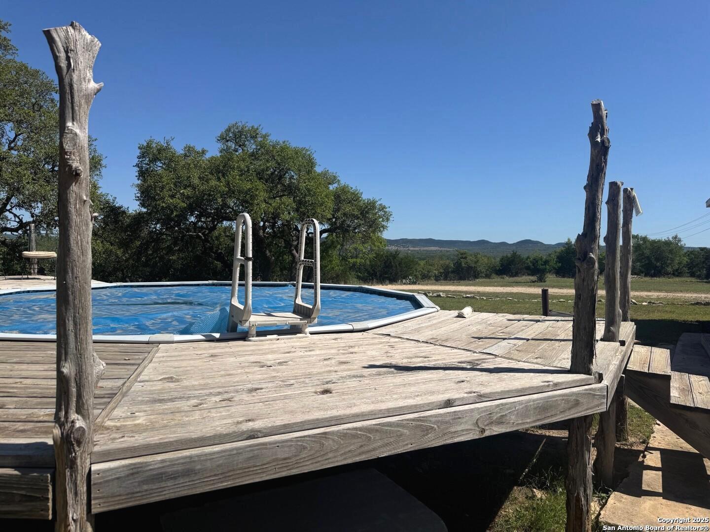 2485 Bump Gate Road Pipe Creek, TX 78063 - Photo 14 of 42 a view of a swimming pool with a patio