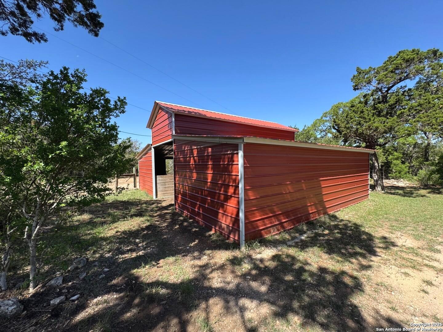 2485 Bump Gate Road Pipe Creek, TX 78063 - Photo 16 of 42 a backyard of a house with plants and tree