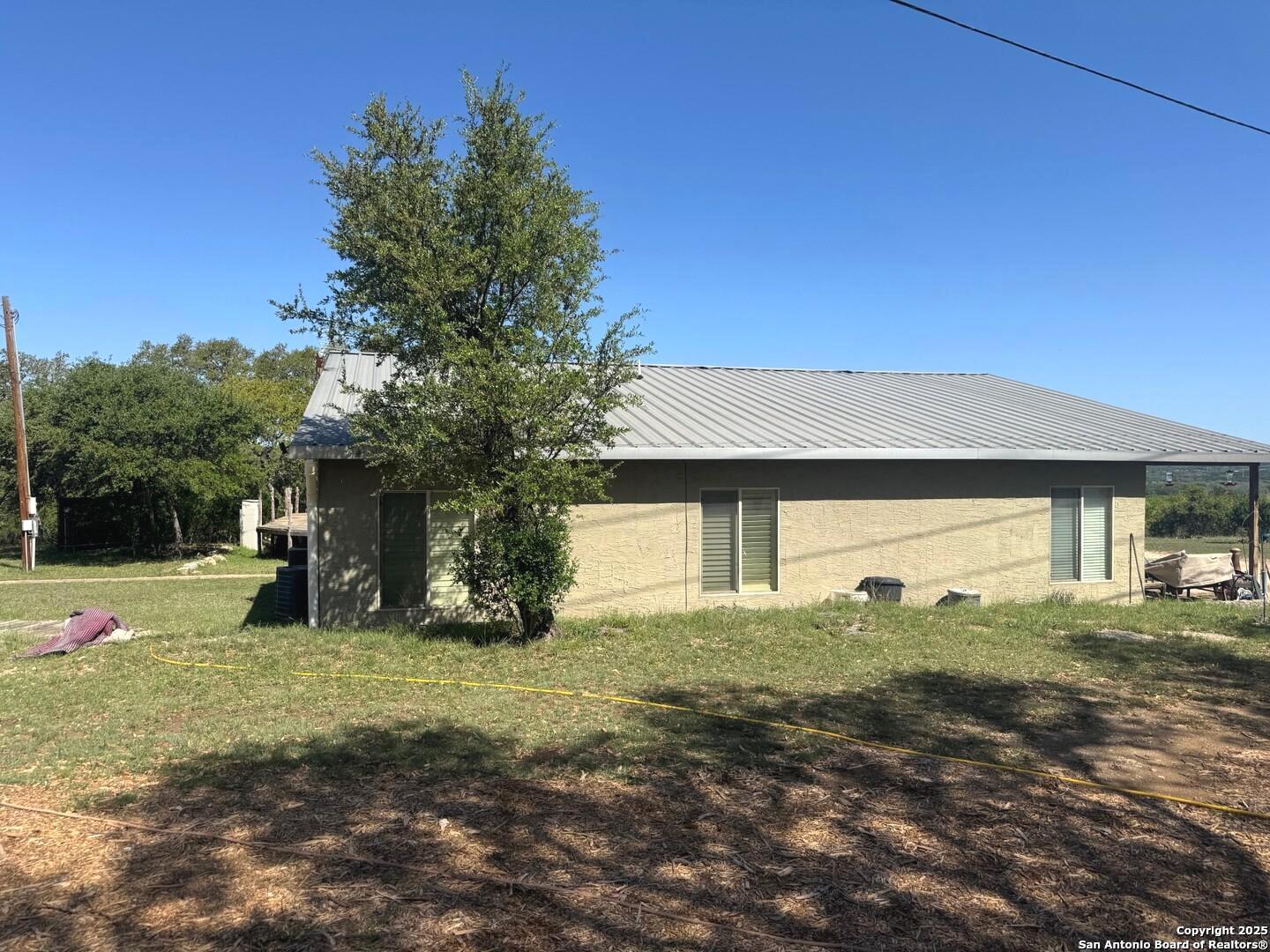 2485 Bump Gate Road Pipe Creek, TX 78063 - Photo 20 of 42 a view of a house with a yard