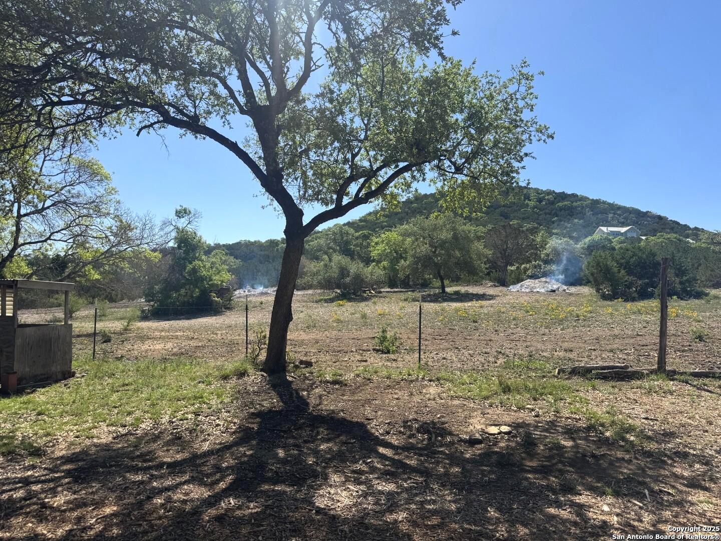 2485 Bump Gate Road Pipe Creek, TX 78063 - Photo 22 of 42 a view of a yard with trees
