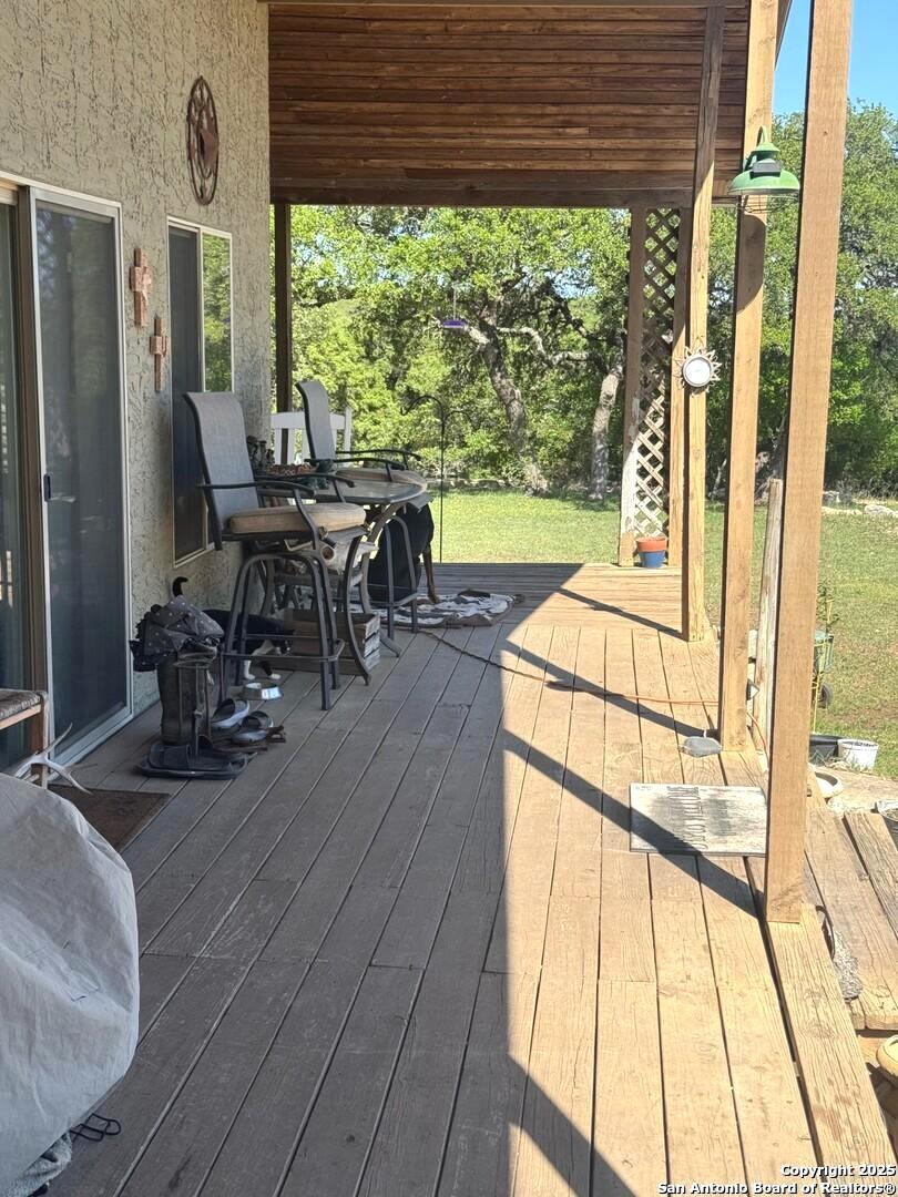 2485 Bump Gate Road Pipe Creek, TX 78063 - Photo 25 of 42 a view of a living room with furniture and floor to ceiling windows