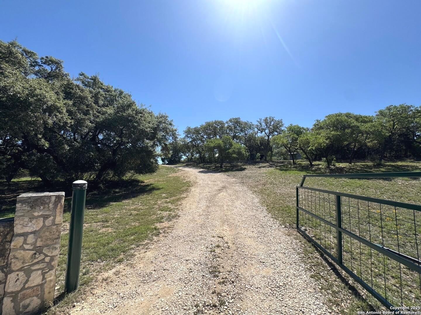 2485 Bump Gate Road Pipe Creek, TX 78063 - Photo 28 of 42 a view of a pathway with a wrought fence