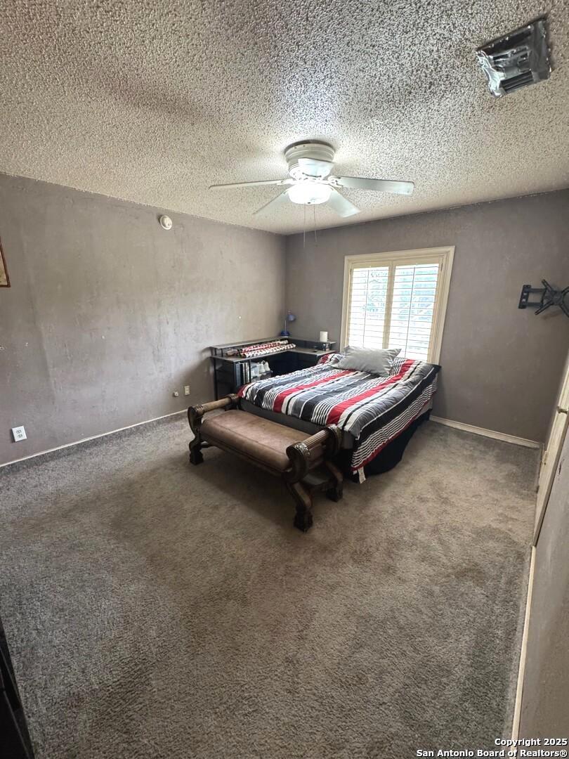 2485 Bump Gate Road Pipe Creek, TX 78063 - Photo 29 of 42 a bed room with a bed and window