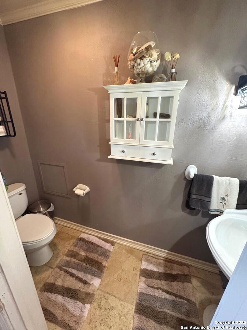 2485 Bump Gate Road Pipe Creek, TX 78063 - Photo 30 of 42 a bathroom with a sink and toilet